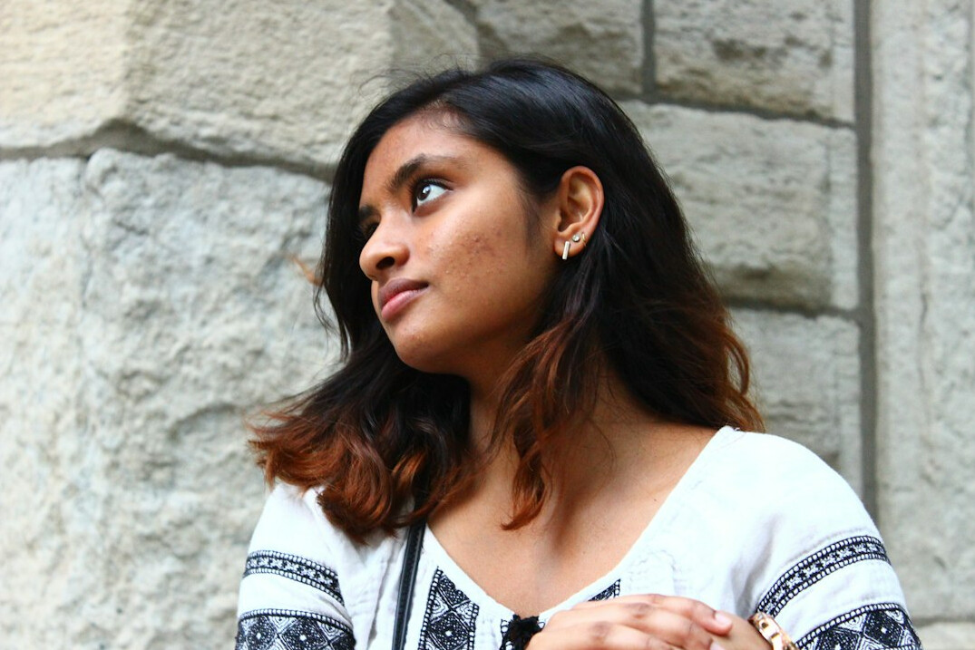 Studio portrait of a South Asian Canadian woman writer smiling