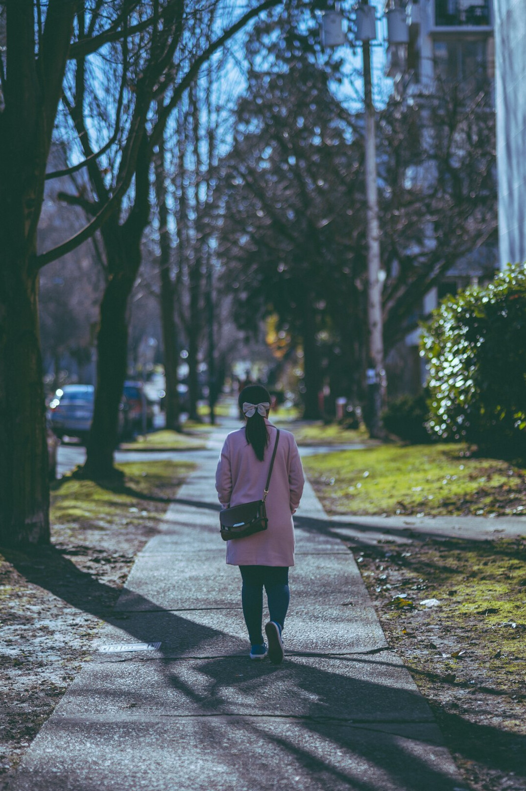 Woman walking and taking notes on a residential Canadian street
